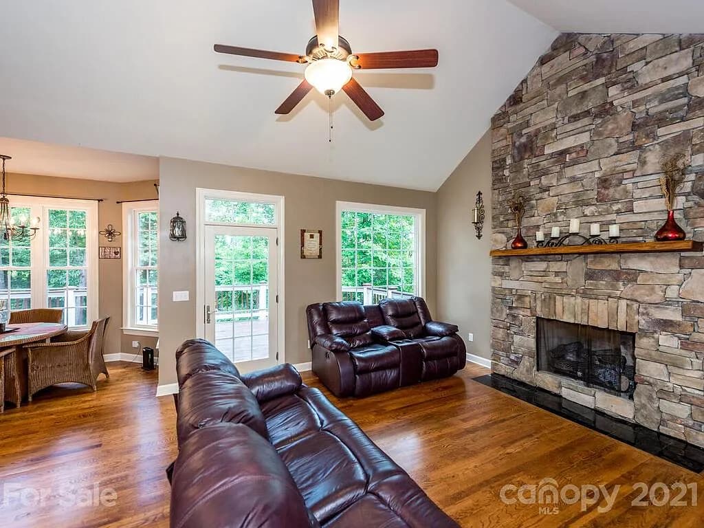 Living room with stone fireplace in mountain home