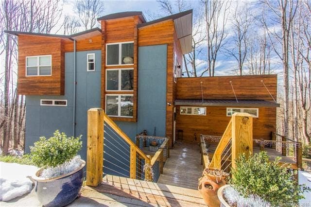 Modern ICF-built home with wood and blue exterior by Blue Ridge Homes