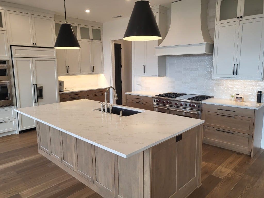 Remodeled kitchen with large island and pendant lighting